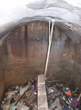 A typical recess of the Western Wall Tunnel before engineering and safety modifications. On the ceiling of the vault is an opening that drains sewage and garbage from the building above. (courtesy of the Western Wall Heritage Foundation)