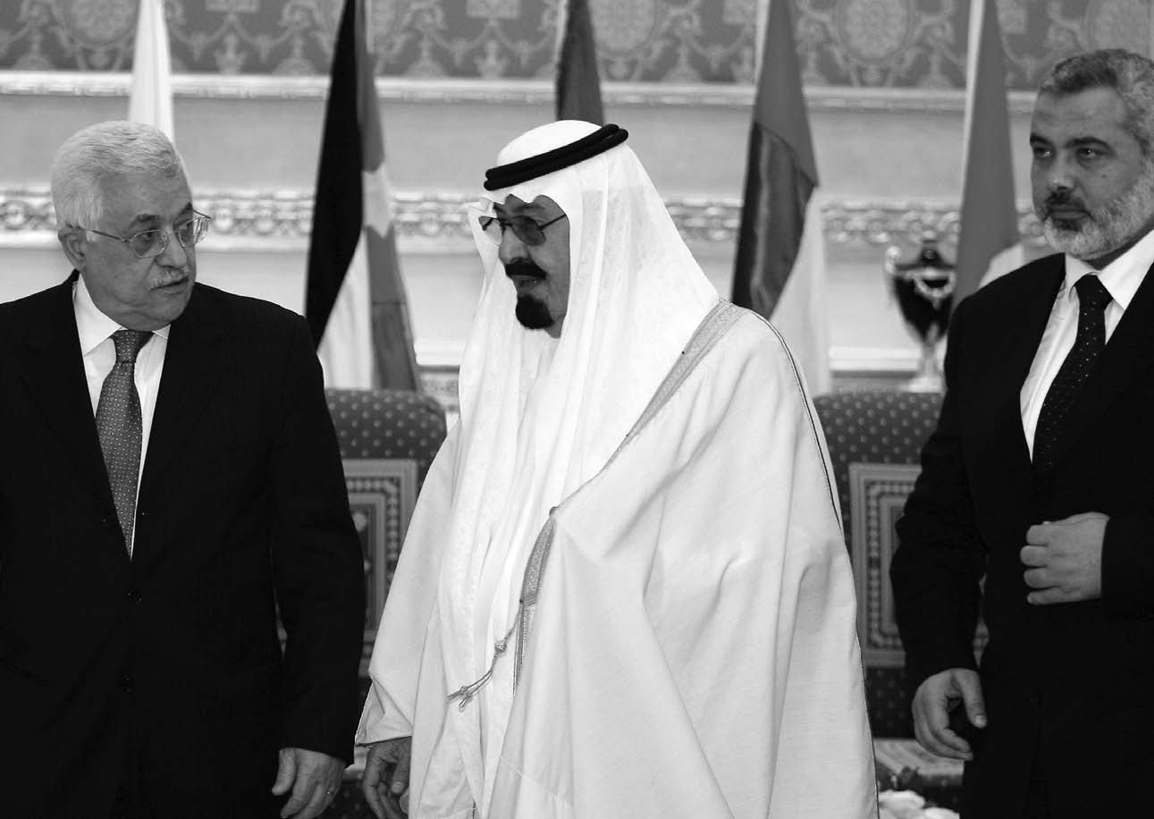 Saudi King Abdullah bin Abd al-Aziz, center, speaks to Palestinian leader Mahmoud Abbas, lef, as Prime Minister Ismail Haniyeh of Hamas, right, looks on in Riyadh on March 27, 2007, prior to an Arab League Summit meeting.